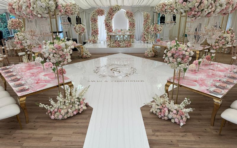 The Grand Pavilion decorated for a wedding reception with white and pink flowers.