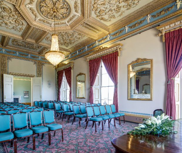 A view of the Drawing Room from the corner in front of the guests and next to a top table. Takes in a view of the detailed ceiling and chandelier.