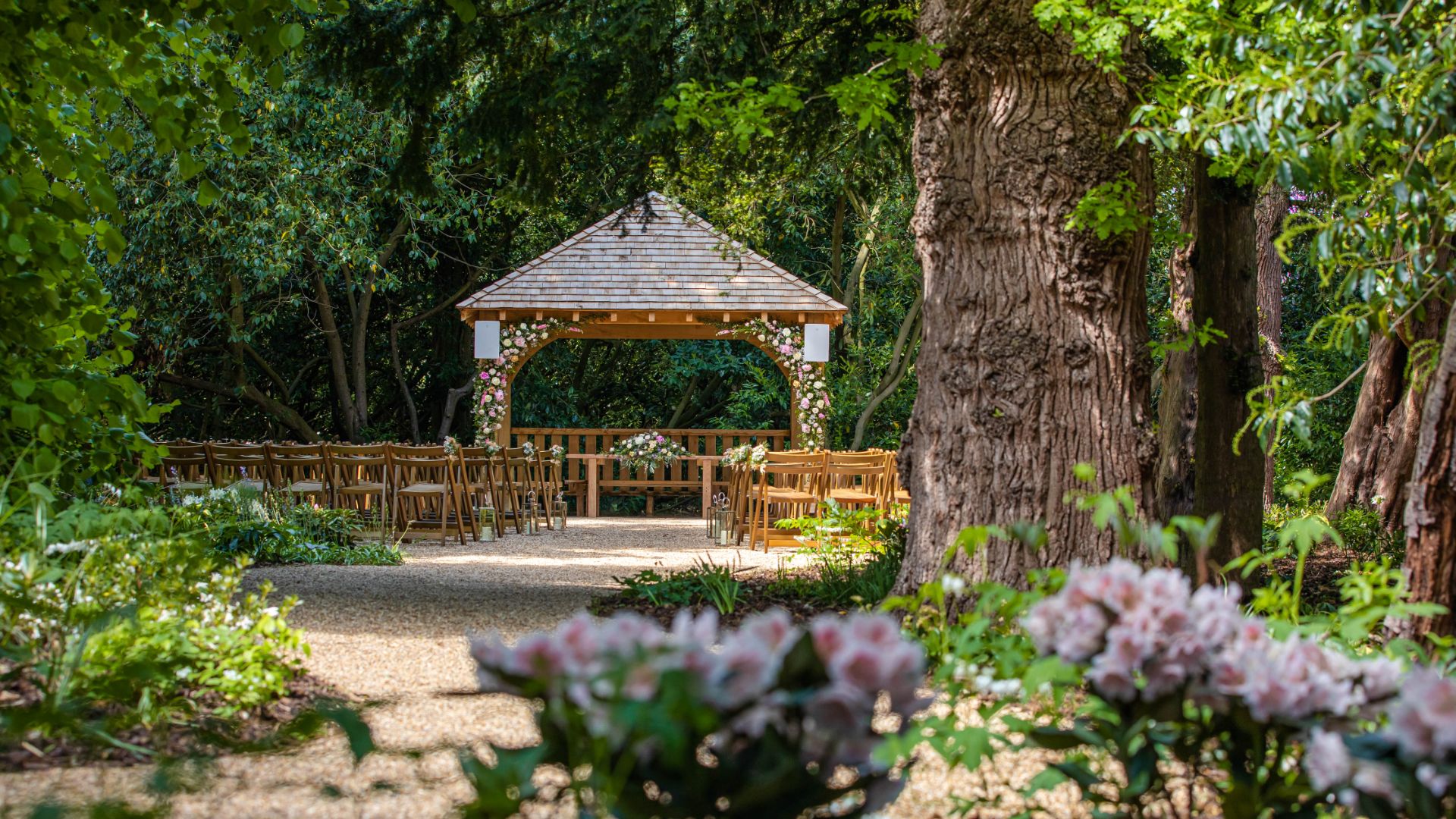 A view of the Outdoor Ceremony Garden taken amongst woodland and flowers