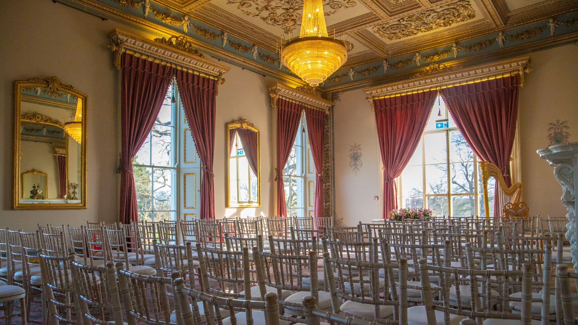 The Drawing Room with white chairs set out for a wedding ceremony