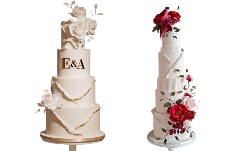 Two white, tiered wedding cakes featuring flower decorations. 